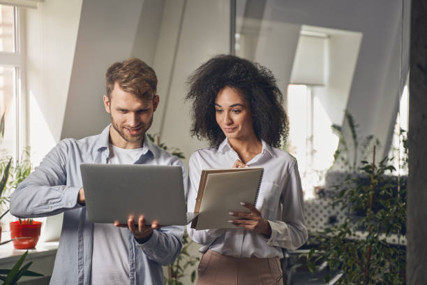 istock Focused lady gazing at her coworker computer 1226613992