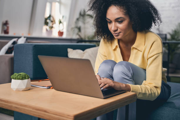 istock Focused young woman working on her laptop 1226614008