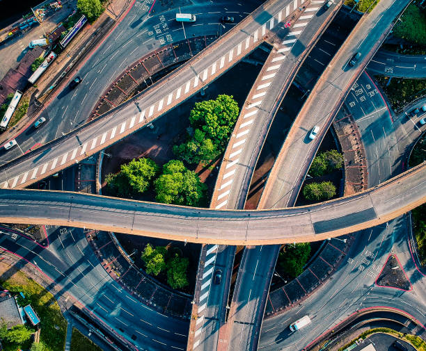 An aerial picture of the junction A picture taken with my drone of our local motorway with extremelylow traffic. And impressive architectural design. overpass road stock pictures, royalty-free photos & images