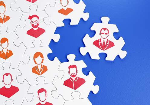 Composed together hexagonal pieces of a jigsaw puzzle with pictured pictograms of staff persons and one of them is outside of a group. 3D-rendering graphics on the theme of 'Business Management'.