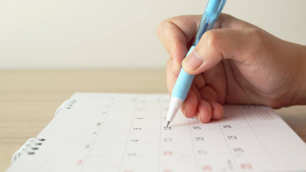 istock Hand with pen writing on calendar date 1226617988