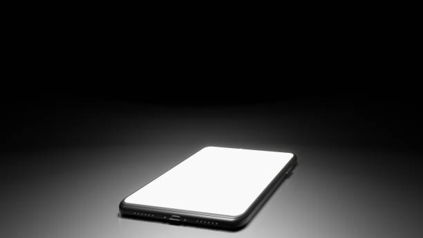 istock 8K 3D Rendered Isolated Smartphone on the Floor in the Dark Room with One Light Source and Screen turn on (middle) 1226619199