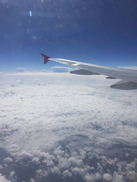 istock Airplane wing, clouds and sky as seen through window of an airplane. 1226619342