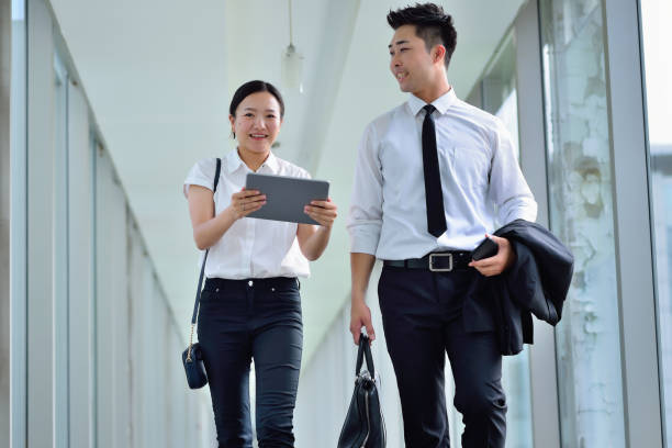 istock Two Young Colleagues Talking and Walking at Aisle 1226619706