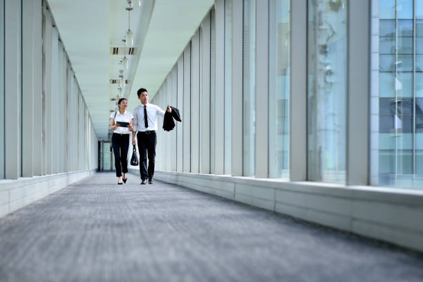 istock Two Young Colleagues Talking and Walking at Aisle 1226619709