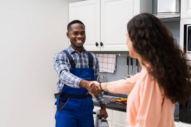 istock Repairman Shaking Hands With Woman 1226620555