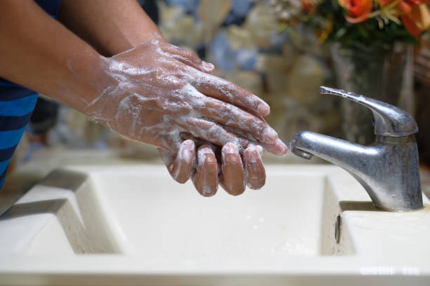 istock hands with soap warm water using hand sanitizer gel 1226621767