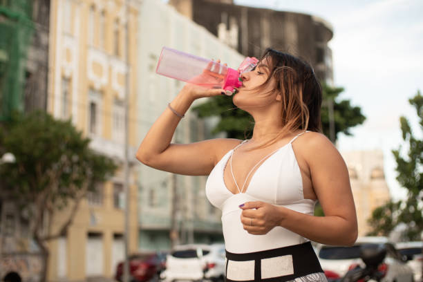 istock Athlete woman drinking water 1226622000