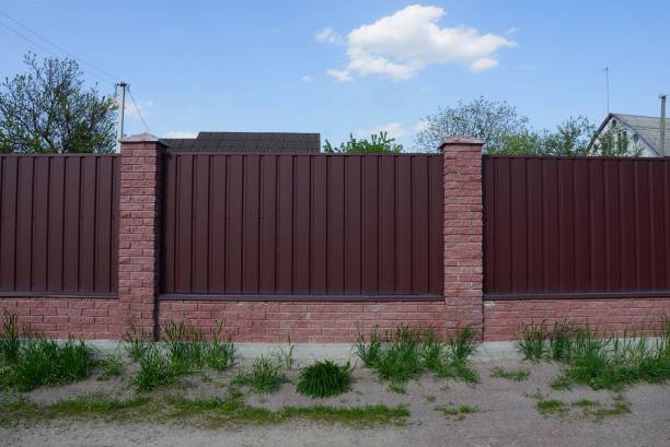 istock brown metal fence wall with bricks 1226627674