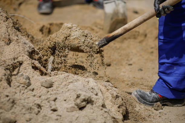 istock Details with a construction worker using a shovel to load sand in a wheelbarrow. 1226627942