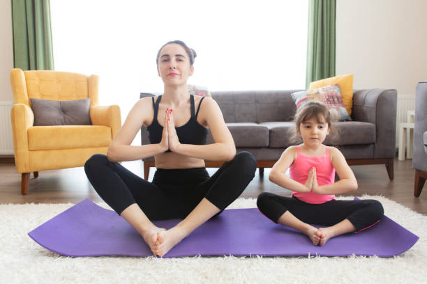 istock Mother and daughter working yoga 1226627976