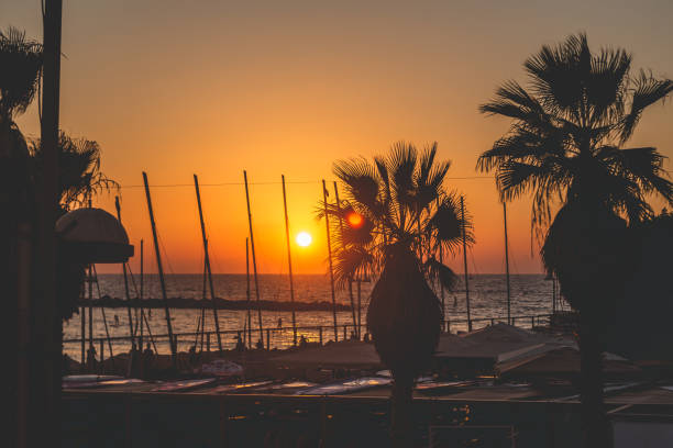 the scenic sunset over the mediterranean sea as seen from the tel aviv promenade - sailboat sunset tel aviv sea imagens e fotografias de stock