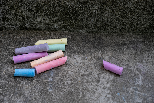 Colorful chalks on concrete floor