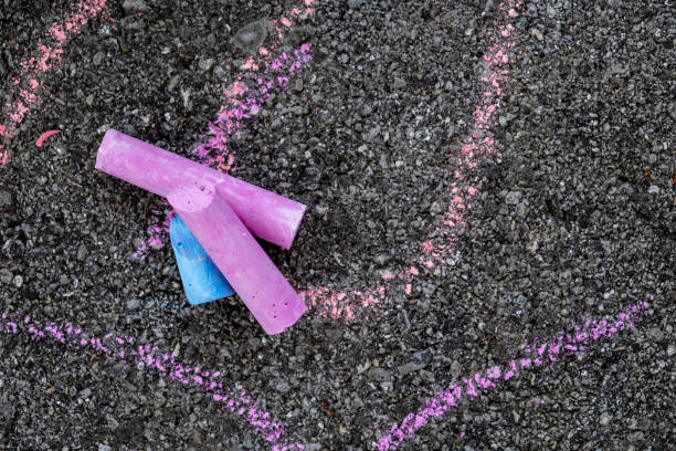 istock Purple chalks and children's drawings on concrete floor 1226628761