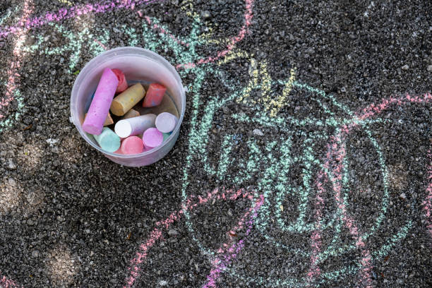 istock Colorful chalks and children's drawings on concrete floor 1226628815