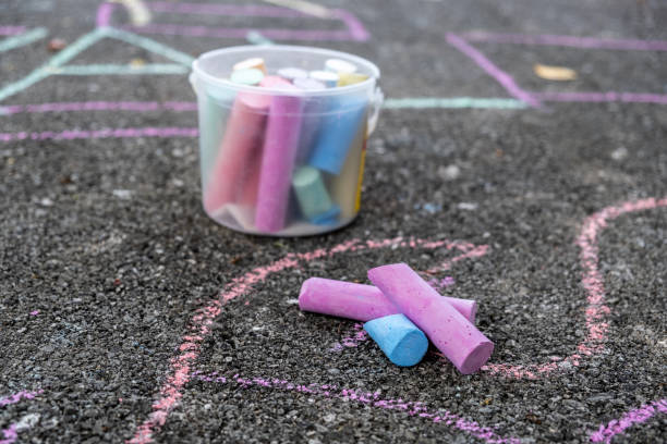 istock Colorful chalks and children's drawings on concrete floor 1226628954