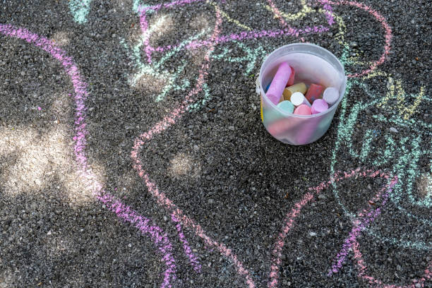 istock Colorful chalks and children's drawings on concrete floor 1226628979