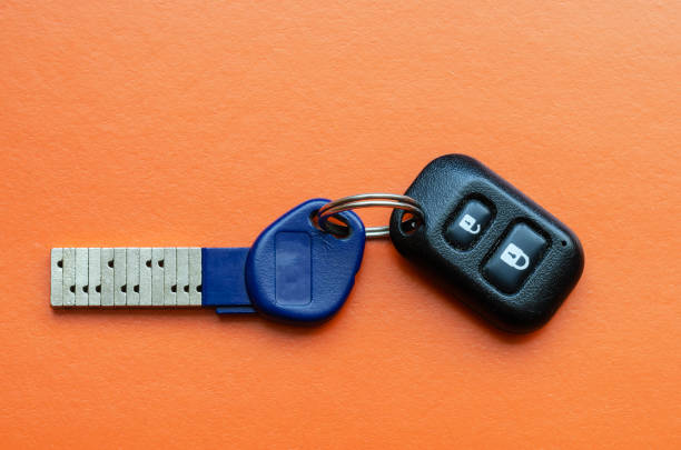 istock Chipped door key with remote control on an orange background 1226630939