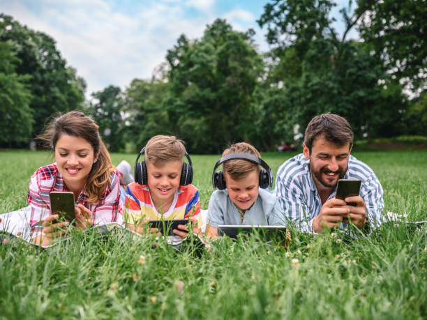 istock Family using mobile phones together in nature. 1226631328
