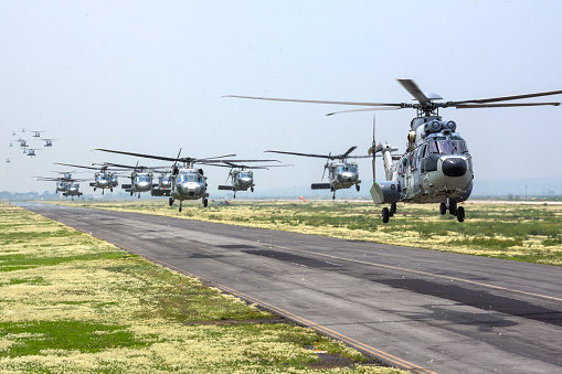 Hidalgo, Mexico - September 11, 2018: General practice of the aerial parade of the anniversary of the independence of Mexico, training landing at Tecamac (Mexico State), being followed by the Sikorsky UH-60M