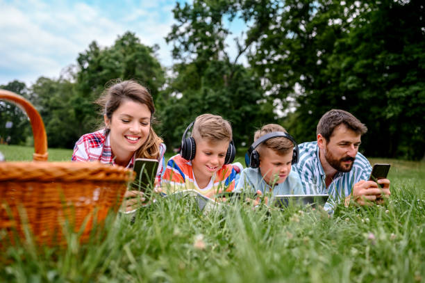 istock Family using mobile phones together in nature. 1226632102