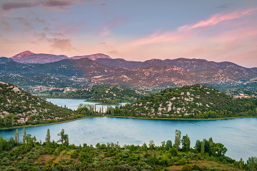 Colorful moody sunset twilight over Bacina Lakes surrounded with with karst mountain range in Dalmatia. Baćina Lakes, Rudine, Dalmatia, Croatia, Southern Europe