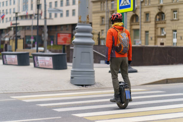 young man driving electric unicycle at the city street - unicycle unicycling cycling wheel imagens e fotografias de stock