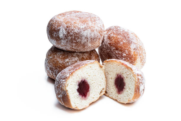 istock Freshly baked doughnuts stuffed with strawberry jam isolated on white 1226635400