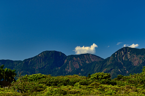 large cumulus cloud with golden tones, illuminated by the evening sun - SAO SEBASTIAO, SAO PAULO, BRAZIL.