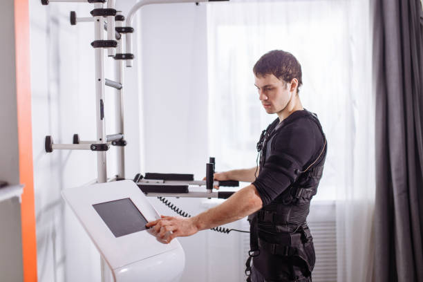 istock athlete regulating intensity of ems electro muscular stimulation machine 1226637766