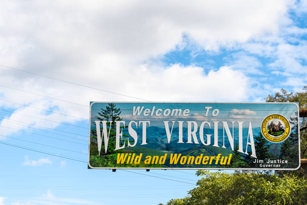 Welcome to West Virginia sign Wild and Wonderful with mountains picture by Kentucky border stock photo