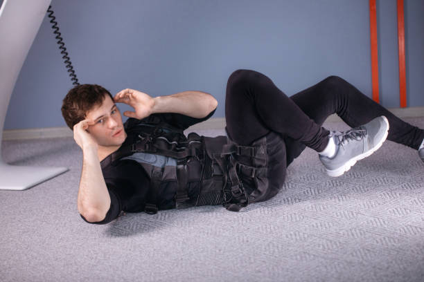 istock athlete wearing ems suit doing abs exercise or sit ups 1226637945