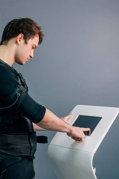 istock athlete regulating intensity of ems electro muscular stimulation machine 1226638362