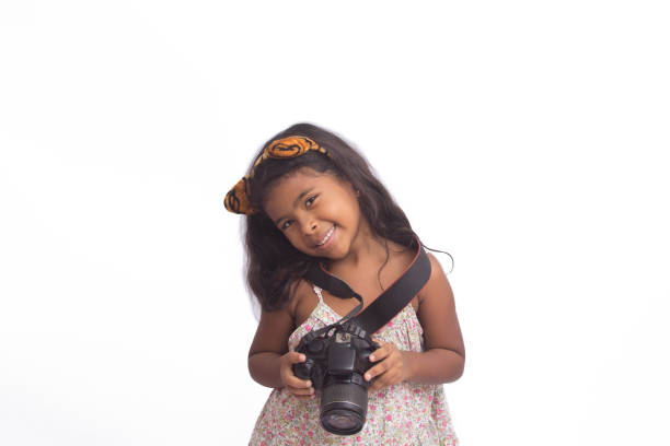 istock Beautiful girl using a digital camera isolated on white. 1226640488