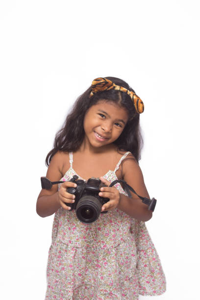 istock Beautiful girl using a digital camera isolated on white. 1226641026