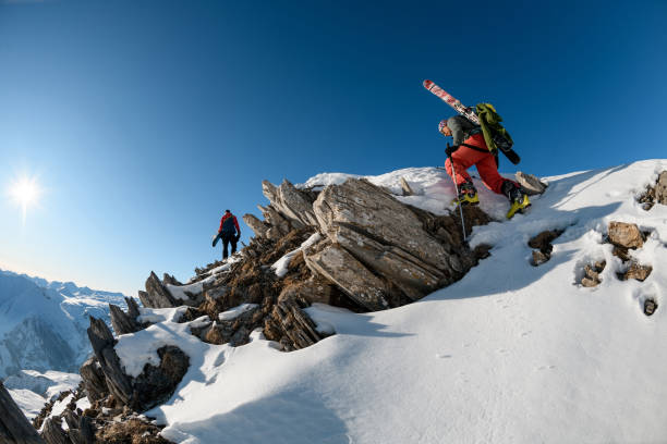 istock beautiful view of snowing stone top mountain with men on it. 1226642500