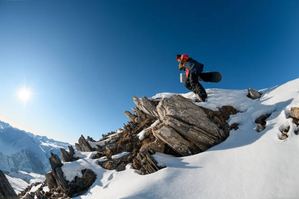 istock gorgeous view of stone top mountain with snowboarder man on it. 1226644657