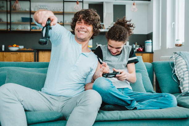 istock Father and son playing digital games at home 1226644787