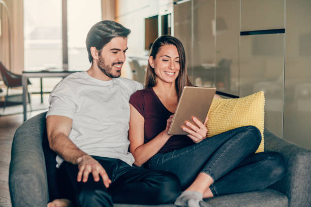 istock Smiling young couple using digital tablet at home. 1226644794