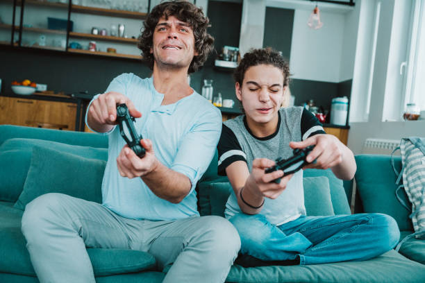 istock Father and son playing digital games at home 1226644806