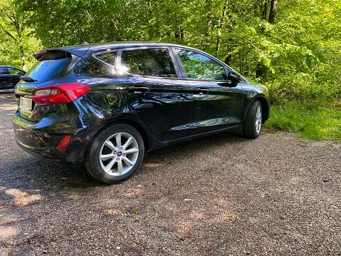 Spiegelberg, Germany - May, 12 - 2020: New Ford Fiesta on a public parking space inmidst forest.