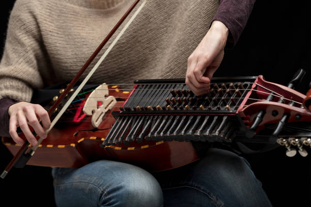 istock Female musician tuning her modern nyckelharpa 1226646978