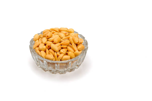 istock Peanuts in glass bowl on white background. 1226648167