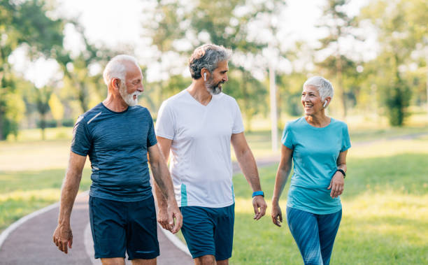 istock Smiling senior athletes jogging in the park 1226652090