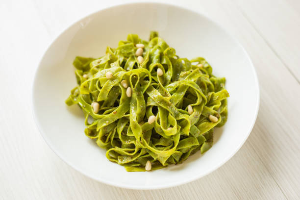 istock Spinach Tagliatelle pasta with pine nuts and pesto sauce. 1226652604