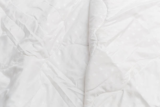 istock White fabric blanket close-up backdrop with selective focus and background blur 1226652685