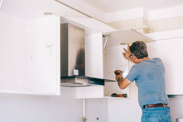 istock repairman repairs kitchen cabinets 1226655377