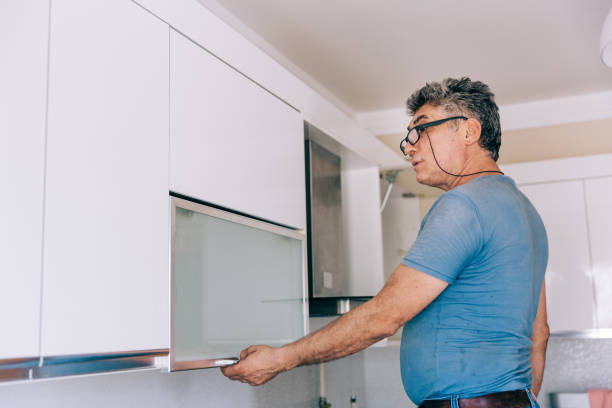 istock repairman repairs kitchen cabinets 1226655383