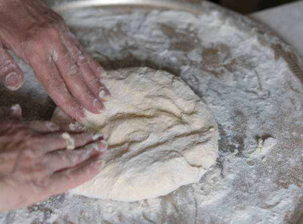 istock Hands knead the dough for further baking 1226655417