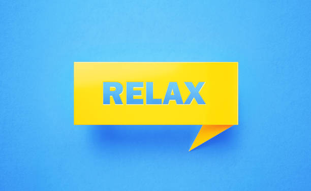Relax written yellow chat bubble on blue background. Horizontal composition with copy space. Relax concept.